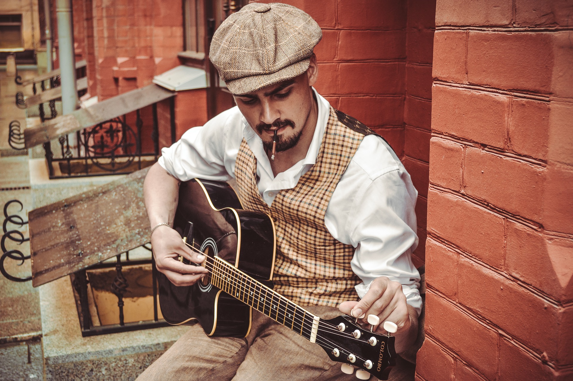 A man playing guitar on the streets of New York.