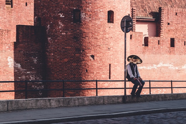 A man with a sombrero sitting alone