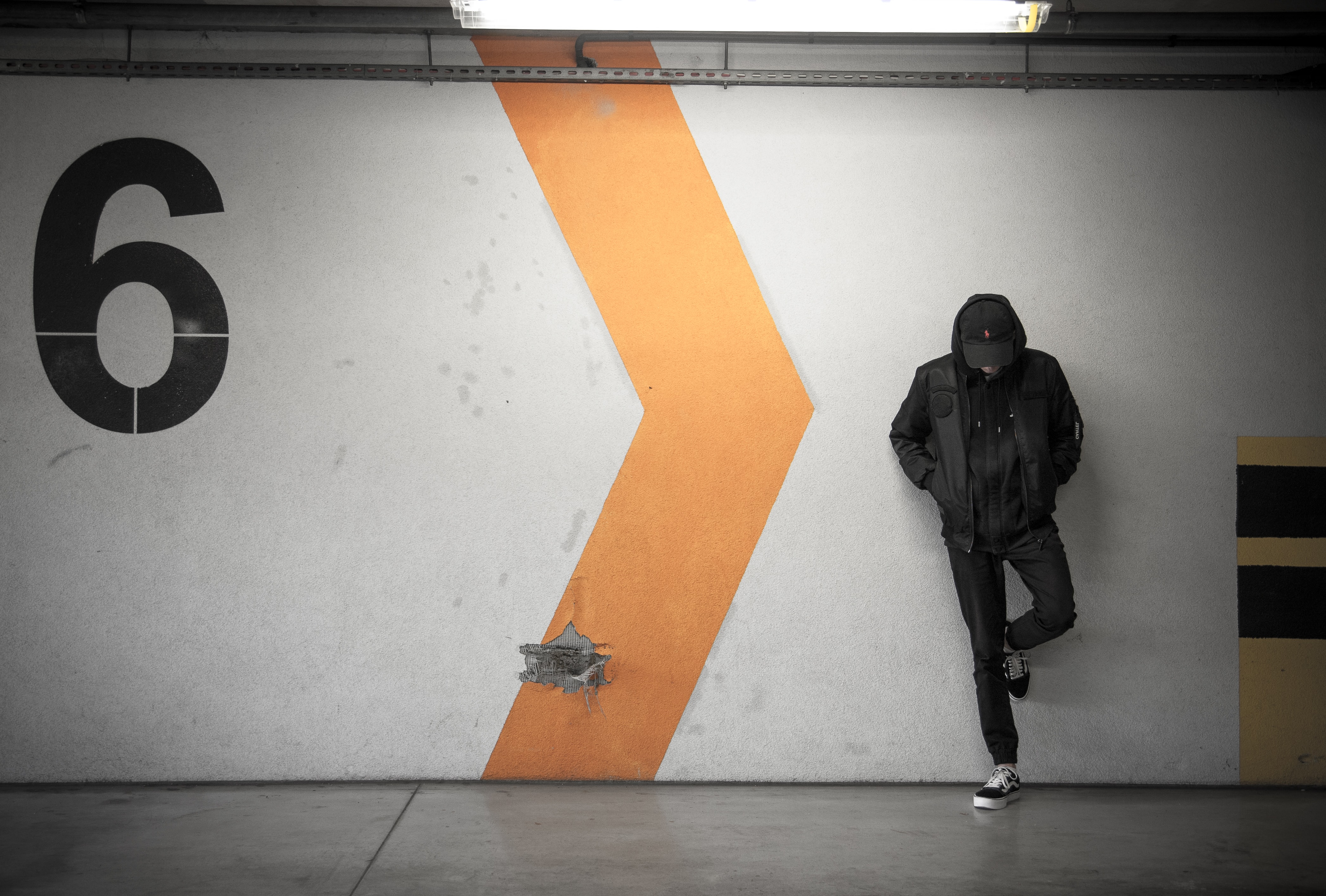 A man leaning against a wall in a NY Subway