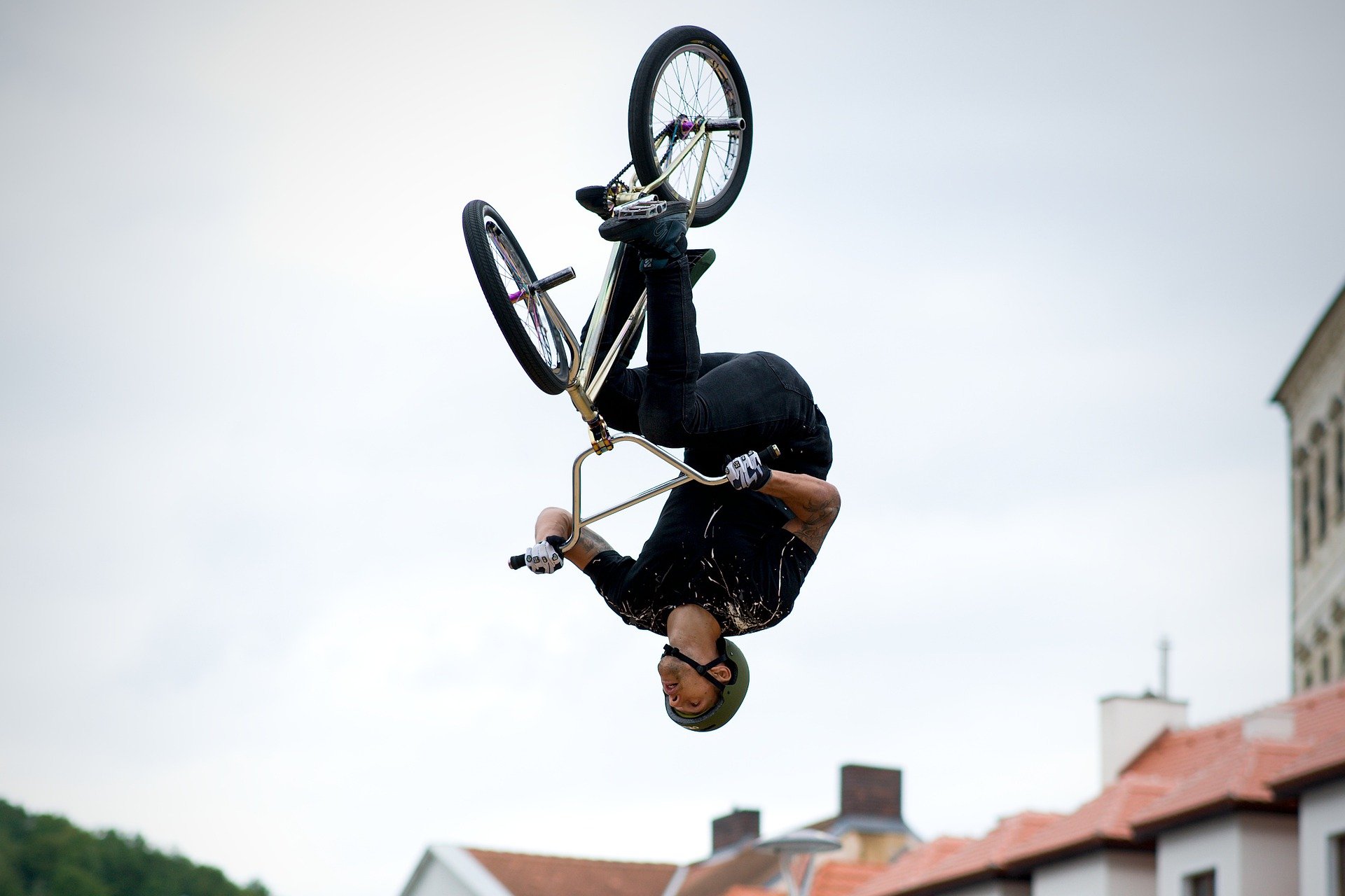 A man doing a flip with his bicycle